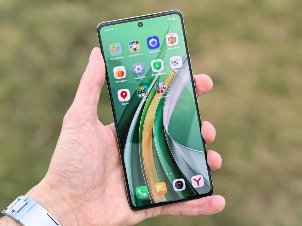 pexels-photo-32436513-32436513 Close-up of a hand holding a smartphone displaying colorful app icons against a blurred background.